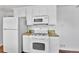 Functional kitchen with white appliances, granite countertops, microwave, oven, and hardwood floors at 4155 S Lipan St, Englewood, CO 80110