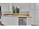 Modern kitchen boasts white cabinets, granite countertops, stainless steel dishwasher, and stylish sink at 4155 S Lipan St, Englewood, CO 80110