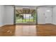 Sun-filled living room features hardwood floors, large window, and freshly painted white walls at 4155 S Lipan St, Englewood, CO 80110