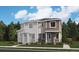 New two-story home featuring stone accents, neutral siding, manicured lawn, and professional landscaping at 24088 E Warm Springs Ave, Aurora, CO 80019