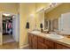 Well-lit bathroom with double vanity, walk-in shower and walk-in closet at 11866 High Desert Rd, Parker, CO 80134