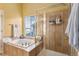 Bright bathroom with tub and glass-enclosed shower at 11866 High Desert Rd, Parker, CO 80134