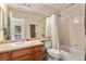 Bright bathroom features a neutral-toned vanity with sink and a shower-tub combination with tile surround at 11866 High Desert Rd, Parker, CO 80134