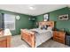 Comfortable bedroom with green walls and a large bed at 11866 High Desert Rd, Parker, CO 80134