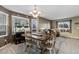 Bright dining room with natural light, a modern chandelier, and an adjacent living area at 11866 High Desert Rd, Parker, CO 80134