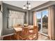 Light-filled dining room with backyard access and wooden table at 11866 High Desert Rd, Parker, CO 80134