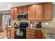 Well-lit kitchen features wooden cabinetry, granite countertops, and stainless steel appliances at 11866 High Desert Rd, Parker, CO 80134