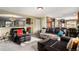 Spacious living room with fireplace, leather seating, and an open layout to other living spaces at 11866 High Desert Rd, Parker, CO 80134