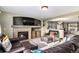 Open-concept living room featuring a fireplace, comfortable seating, and an adjacent dining area at 11866 High Desert Rd, Parker, CO 80134