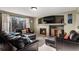 Comfortable living room with fireplace, large windows, and plush leather seating at 11866 High Desert Rd, Parker, CO 80134