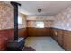 Unfinished basement with wood paneling and a wood-burning stove at 1490 S Glencoe St, Denver, CO 80222