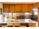 Kitchen with wood cabinets and a double sink at 1490 S Glencoe St, Denver, CO 80222