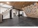 Finished basement featuring a climbing wall, rubber floor, and comfortable seating area at 236 Harris Dr, Idaho Springs, CO 80452