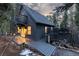 The exterior of this home has a charming deck and inviting entryway, nestled among the trees at 236 Harris Dr, Idaho Springs, CO 80452