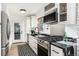 Modern kitchen featuring stainless steel appliances, sleek black countertops, and white cabinetry at 236 Harris Dr, Idaho Springs, CO 80452