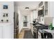 Well-lit kitchen with stainless steel appliances, dark countertops, and a view to the outside at 236 Harris Dr, Idaho Springs, CO 80452