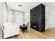 Bright living room with modern black fireplace, light wood floors and contemporary furniture at 236 Harris Dr, Idaho Springs, CO 80452
