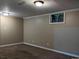 This is a finished basement with neutral color walls, and two windows at 1500 S Perry St, Denver, CO 80219