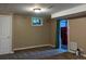 Finished basement with neutral color walls, carpeting, and a peek at the utility room at 1500 S Perry St, Denver, CO 80219