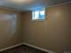 Small basement bedroom with carpet, panelling and a window to let in natural light at 1500 S Perry St, Denver, CO 80219