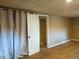 Cozy bedroom features neutral carpet, closet, and a door for convenient basement living at 1500 S Perry St, Denver, CO 80219