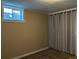 Basement bedroom with panelled walls, carpet and a window, providing a cozy retreat at 1500 S Perry St, Denver, CO 80219