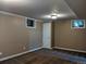 Finished basement with a neutral color scheme, two small windows, and carpeting at 1500 S Perry St, Denver, CO 80219