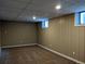 Unfinished basement offers potential for customization with paneled walls and neutral carpeting at 1500 S Perry St, Denver, CO 80219
