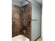 Bathroom with tiled shower, metal shower head, and a towel rack at 1500 S Perry St, Denver, CO 80219