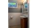 Basement bathroom with a modern sink, vanity and mirror, and a partially visible window at 1500 S Perry St, Denver, CO 80219