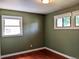 Cozy bedroom with hardwood floors, neutral walls, and natural light from the windows at 1500 S Perry St, Denver, CO 80219