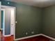Bedroom with neutral walls, hardwood flooring, and a doorway to another room at 1500 S Perry St, Denver, CO 80219