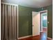 Bedroom featuring neutral wall color, hardwood floors, and a curtained closet at 1500 S Perry St, Denver, CO 80219