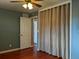 This bedroom features light blue colored walls, a door leading into another room, and a closet with curtain doors at 1500 S Perry St, Denver, CO 80219