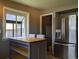 Bright and modern kitchen featuring a dining nook, stainless steel refrigerator, and ample counter space at 1500 S Perry St, Denver, CO 80219