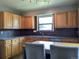 Functional kitchen featuring ample cabinet space, granite countertops, and modern lighting at 1500 S Perry St, Denver, CO 80219