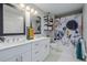 Bright bathroom with double sink vanity, and a shower/tub with a modern patterned curtain at 1975 N Grant St # 509, Denver, CO 80203