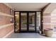 Welcoming building entrance with glass doors, brick facade, and security features at 1975 N Grant St # 509, Denver, CO 80203