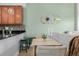 Dining area with kitchen bar and a view into the living room featuring stylish decor at 1975 N Grant St # 509, Denver, CO 80203