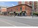 Charming brick building at street corner with awnings over the commercial space on the main floor at 1975 N Grant St # 509, Denver, CO 80203