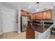 This kitchen features wood cabinets, stainless steel appliances and a sleek dark countertop at 1975 N Grant St # 509, Denver, CO 80203