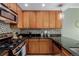 Cozy kitchen features wooden cabinetry, stainless steel appliances, and decorative backsplash at 1975 N Grant St # 509, Denver, CO 80203