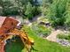 Beautiful backyard with a playhouse, a rock water feature, and mature landscaping at 12705 Kalamath Ct, Westminster, CO 80234
