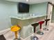 Basement features a stylish bar area with colorful stools and a unique countertop design at 12705 Kalamath Ct, Westminster, CO 80234