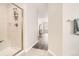Bathroom with glass shower adjacent to hallway and view of the bedroom at 12705 Kalamath Ct, Westminster, CO 80234