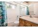 Bathroom featuring tub with shower, window, sink and vanity at 12705 Kalamath Ct, Westminster, CO 80234
