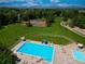 Aerial view of the community pool, tennis courts, and green spaces with mountain views at 12705 Kalamath Ct, Westminster, CO 80234