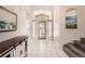 Bright foyer featuring tile flooring, archway and ample natural light creates an inviting entrance at 12705 Kalamath Ct, Westminster, CO 80234