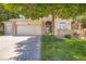 Charming brick home with a well-manicured lawn, mature tree, and American flag for a welcoming curb appeal at 12705 Kalamath Ct, Westminster, CO 80234