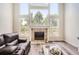 Bright living room with a fireplace, large windows, and stylish flooring offers a comfortable space at 12705 Kalamath Ct, Westminster, CO 80234